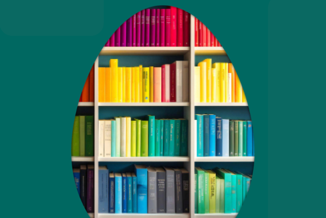 Na obrazku widać kształt jajka wypełniony kolorowymi książkami ustawionymi na regale. Obok jajka widać życzenia świąteczne: "Zdrowych i pogodnych Świąt Wielkanocnych życzy Dyrekcja i Pracownicy Biblioteki Kraków"
